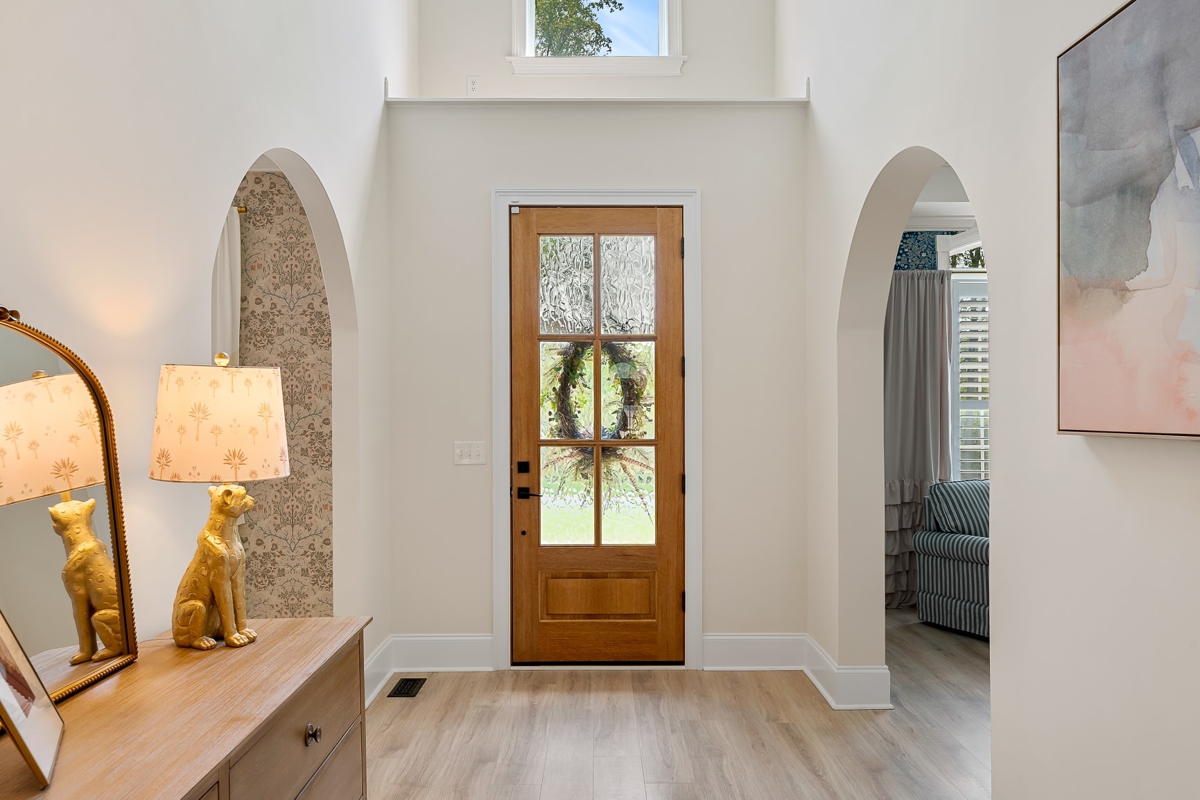 Grand foyer with arched alcoves and gold accents