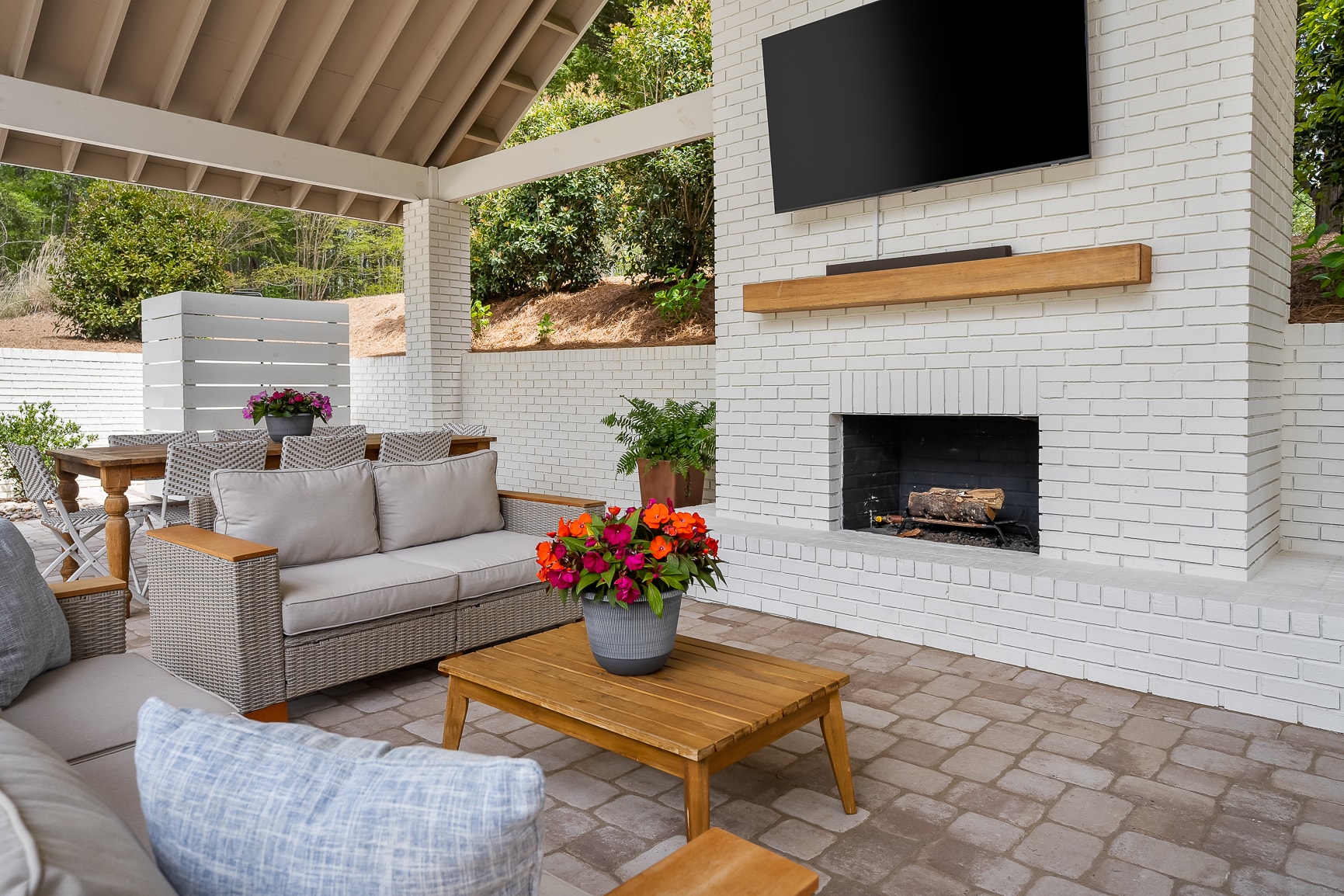 Covered outdoor living area with fireplace